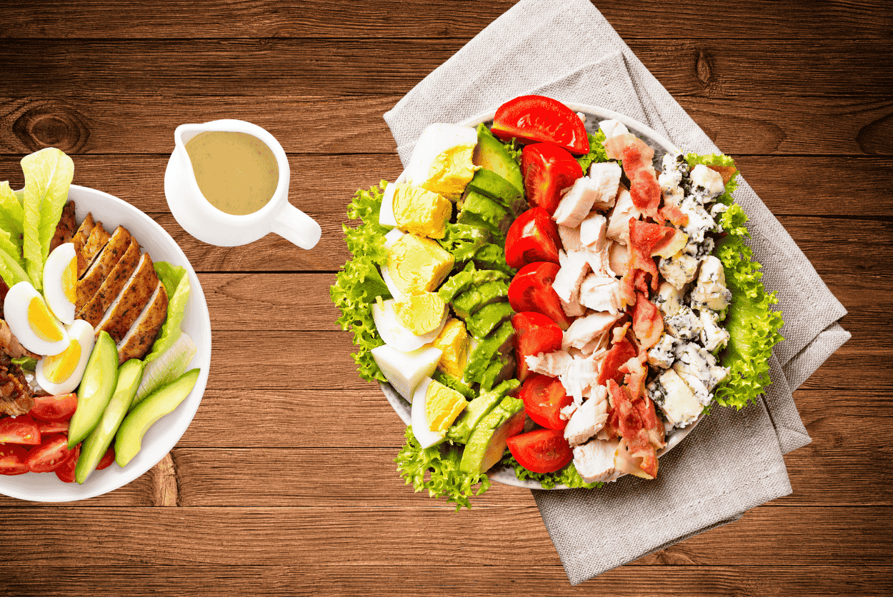 Cobb salad recipe with avocado, bacon, eggs, chicken, and blue cheese.