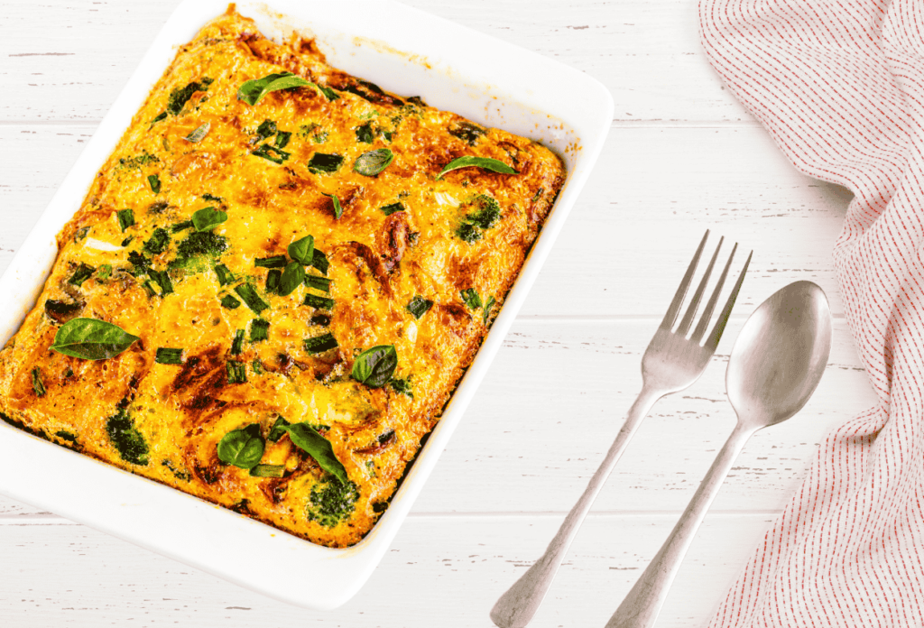 golden Zucchini Breakfast Casserole in a baking dish, topped with fresh herbs and melted cheese, ready to be served for a nutritious morning meal.